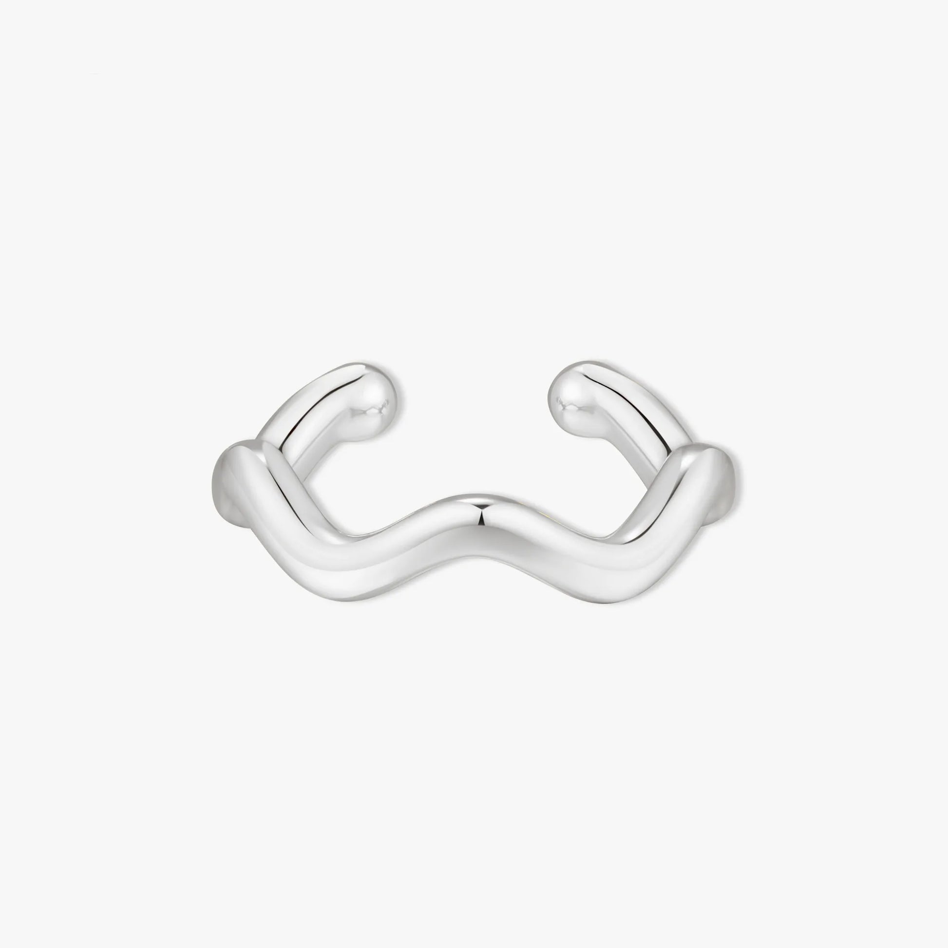 Silver ear cuff with wavy design on a white background
