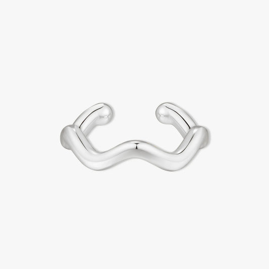 Silver ear cuff with wavy design on a white background
