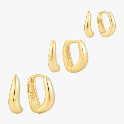 Set of gold hoop earrings on a white background