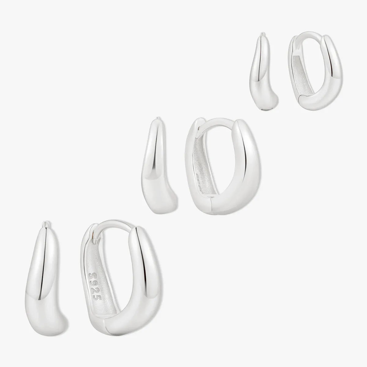 Set of silver hoop earrings on a white background