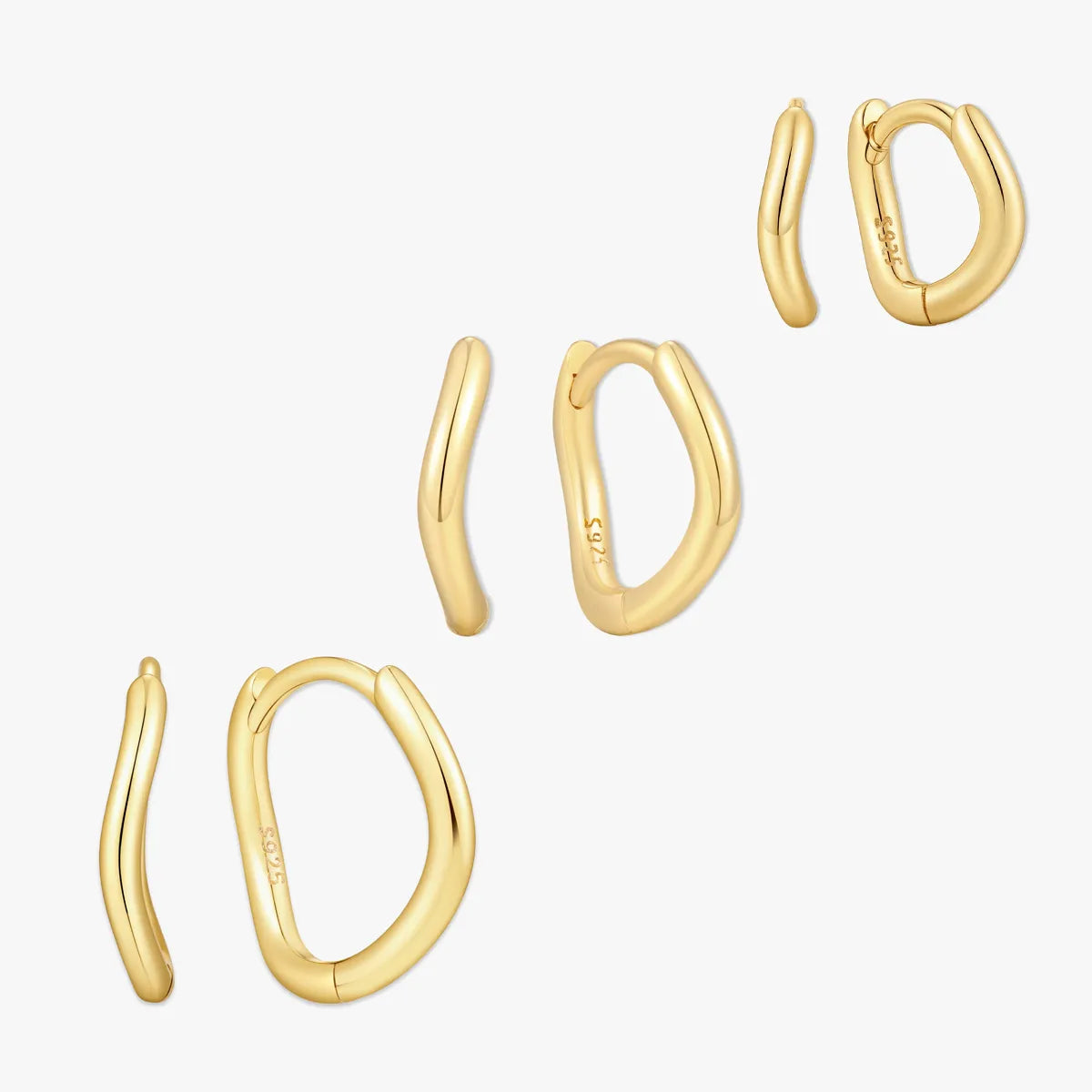 Set of gold hoop earrings on a white background