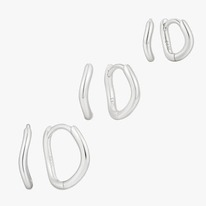 Set of silver hoop earrings on a white background