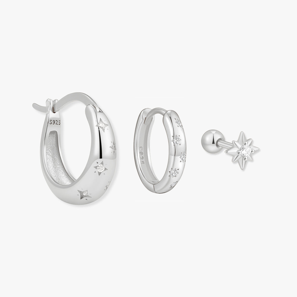 Silver hoop earrings and a star-shaped earring on a white background