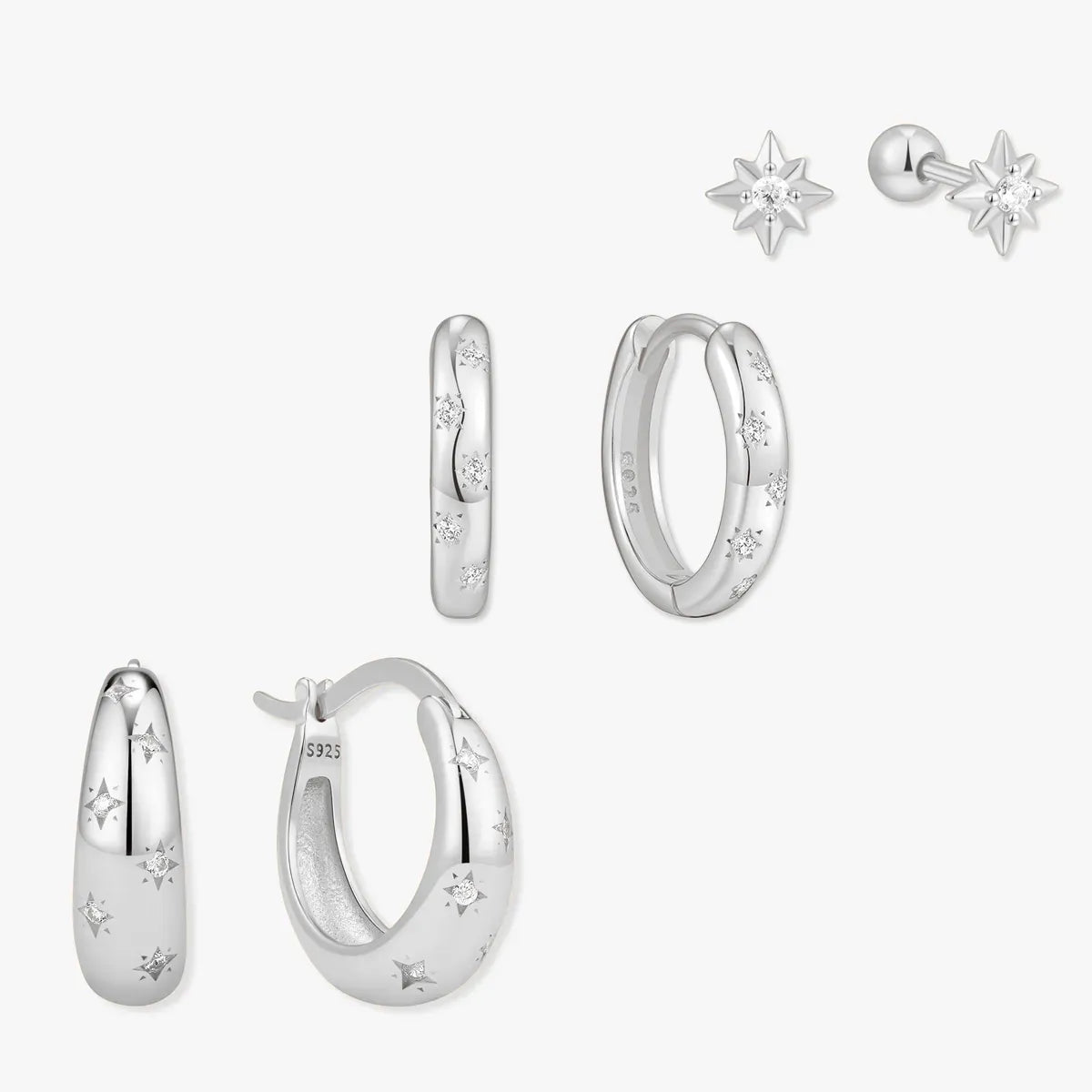 Set of silver earrings on a white background