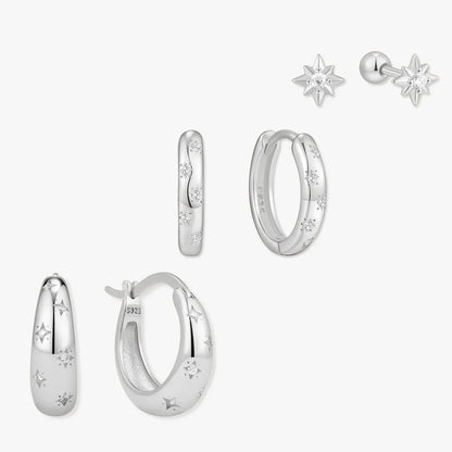Set of silver earrings on a white background