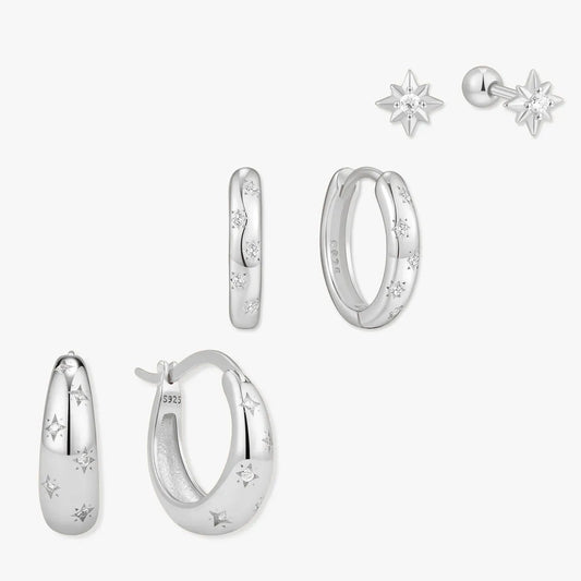 Set of silver earrings on a white background