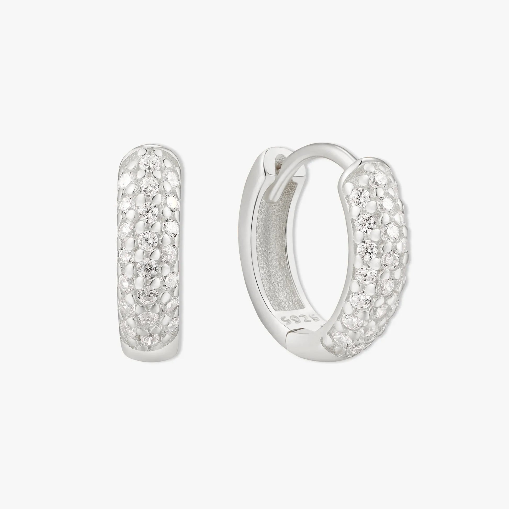Silver hoop earrings with embedded stones on a white background