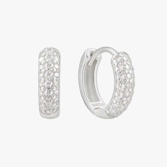 Silver hoop earrings with embedded stones on a white background