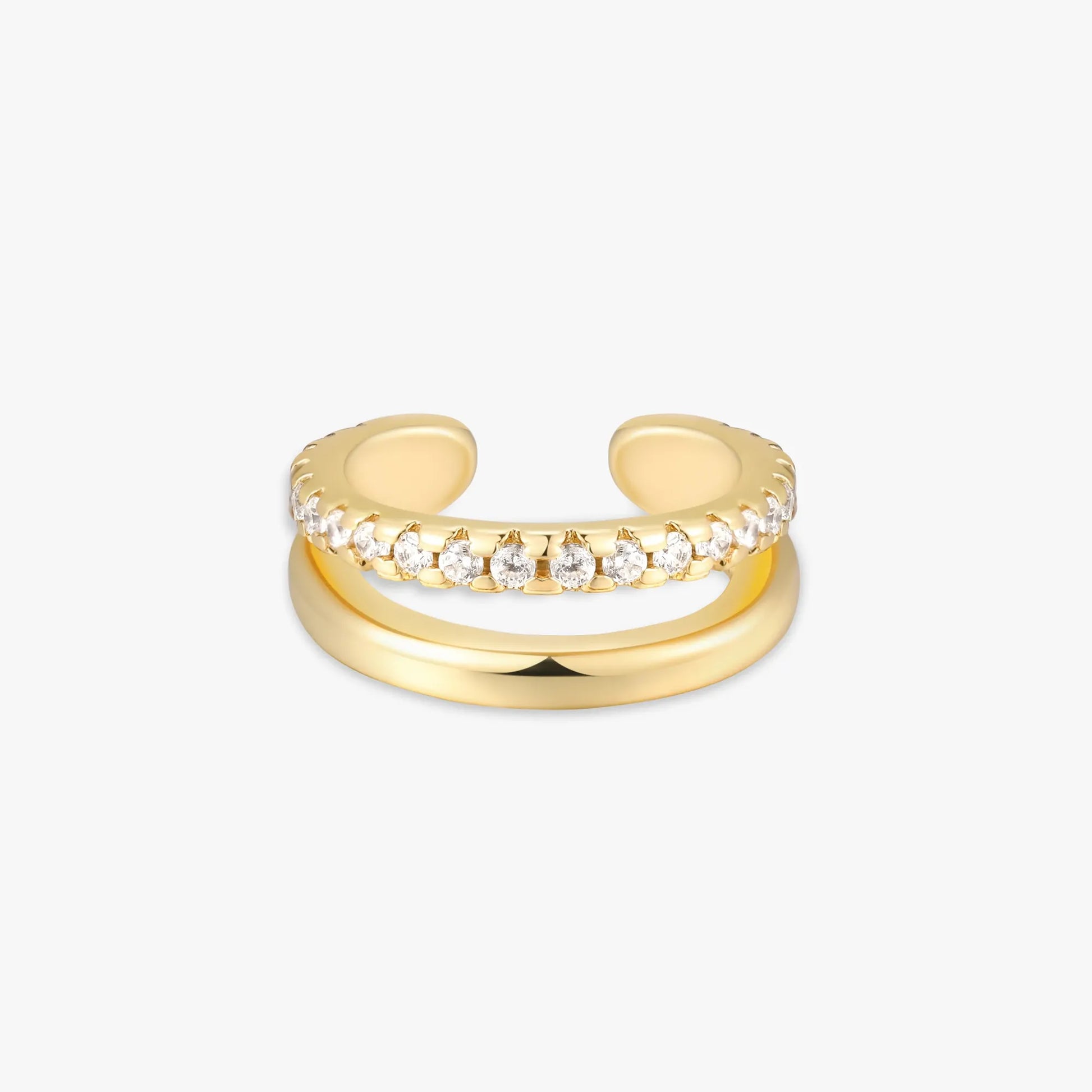 Gold ear cuff with embedded diamonds on a white background