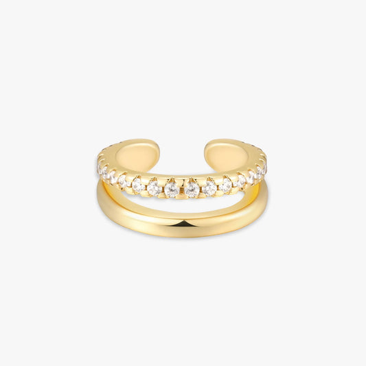 Gold ear cuff with embedded diamonds on a white background
