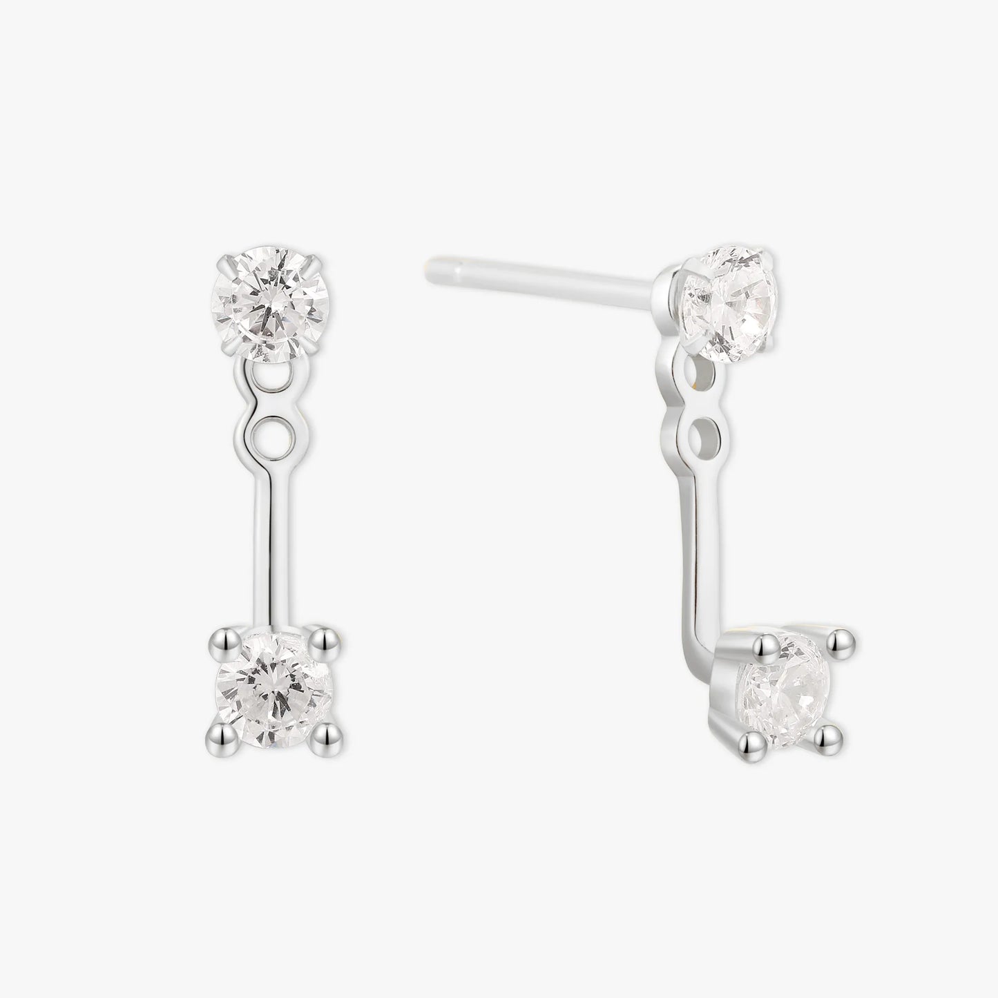 Pair of silver earrings with clear gemstones on a white background