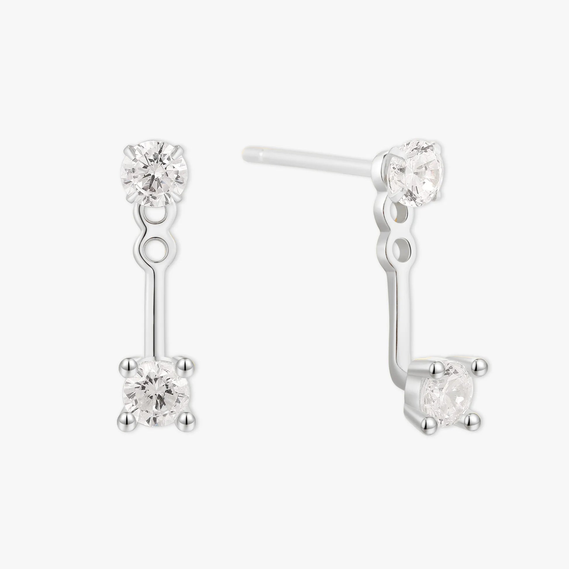 Pair of silver earrings with clear gemstones on a white background