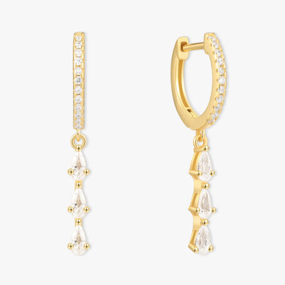 Gold hoop earrings with clear gemstones on a white background