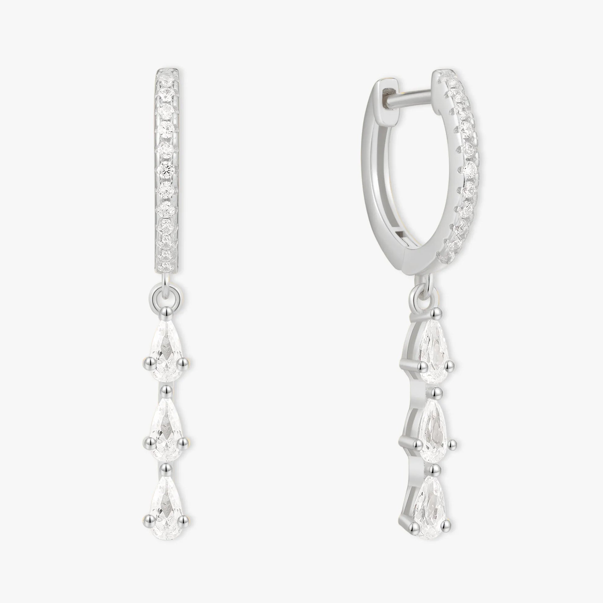 Silver hoop earrings with teardrop-shaped gemstones on a white background