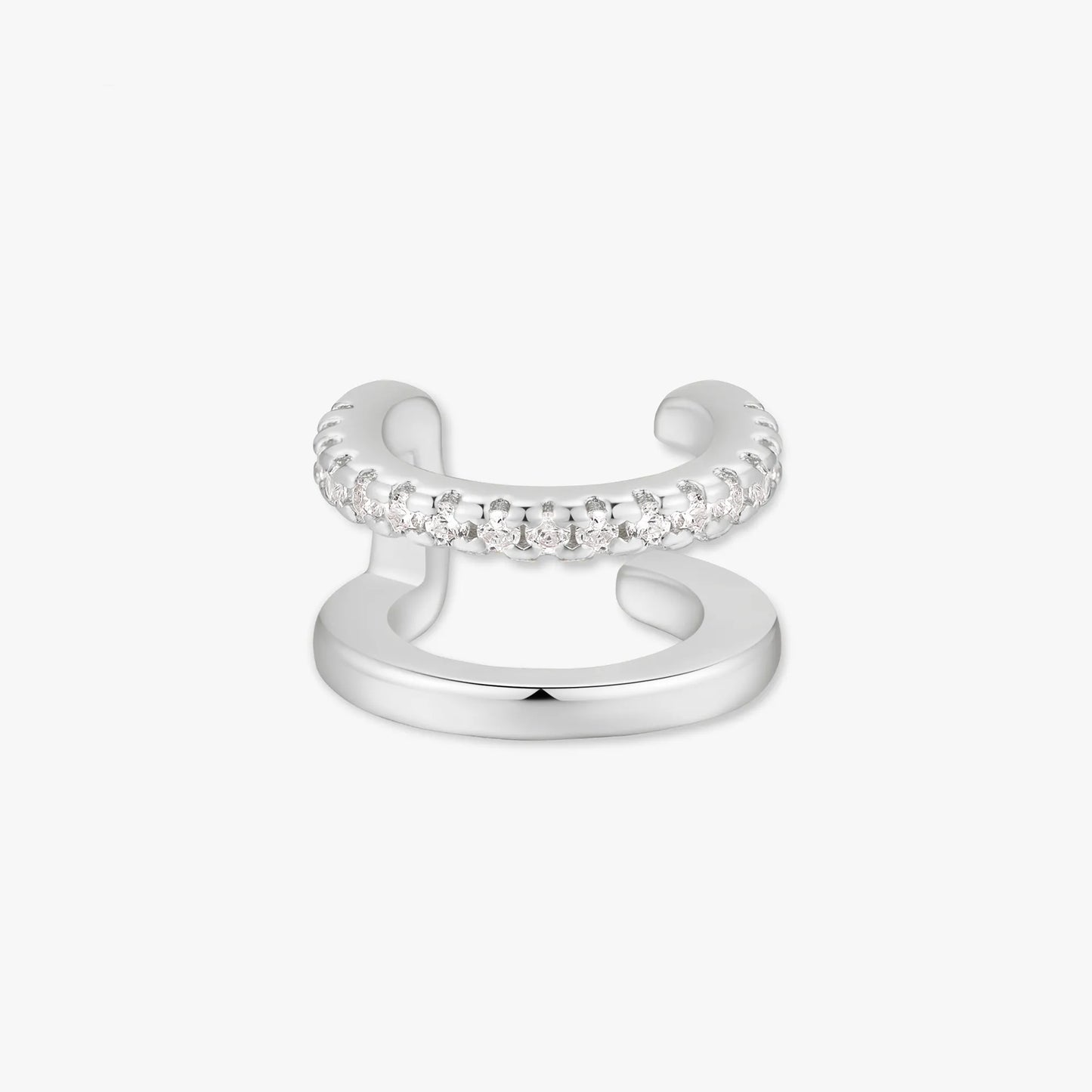 Silver ear cuff with embedded stones on a white background