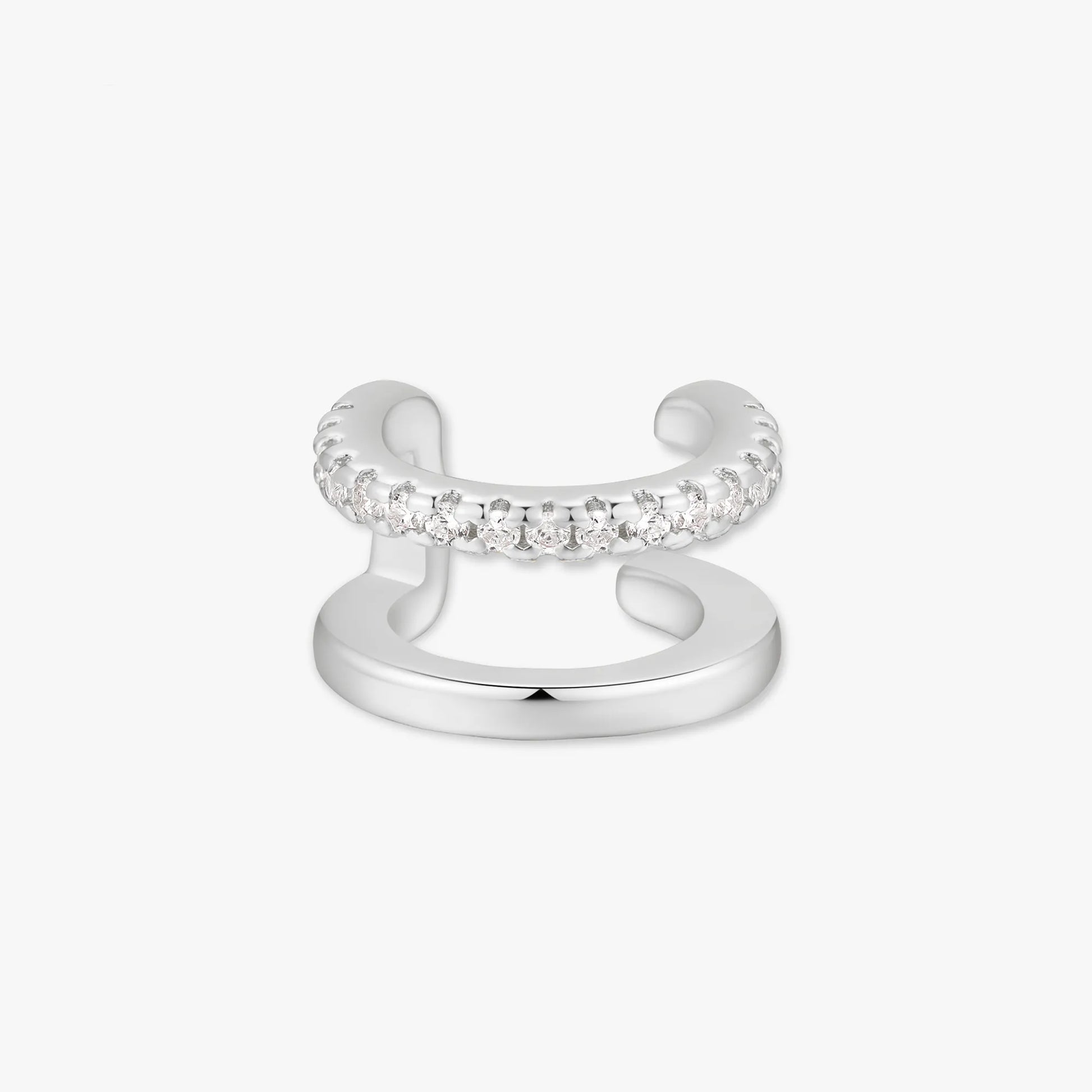 Silver ear cuff with embedded stones on a white background
