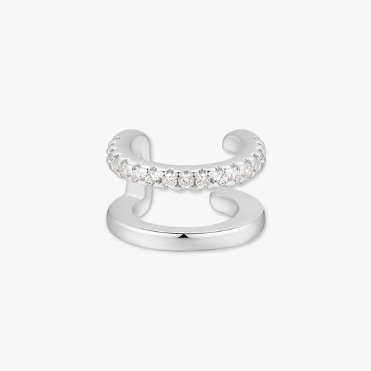 Silver ear cuff with embedded stones on a white background