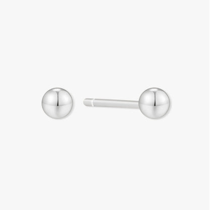Pair of silver ball earrings on a white background