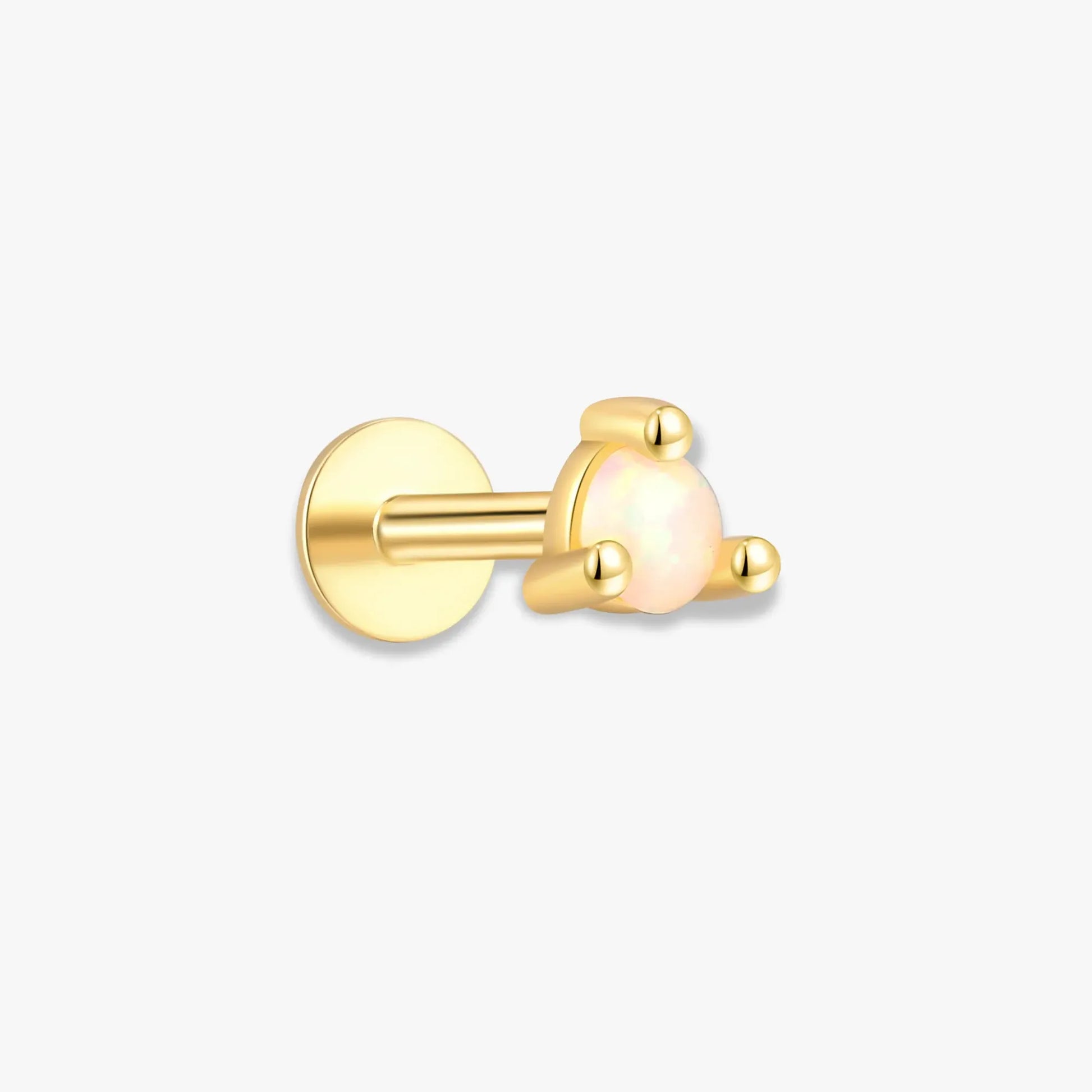 Gold earring with a white gemstone on a white background