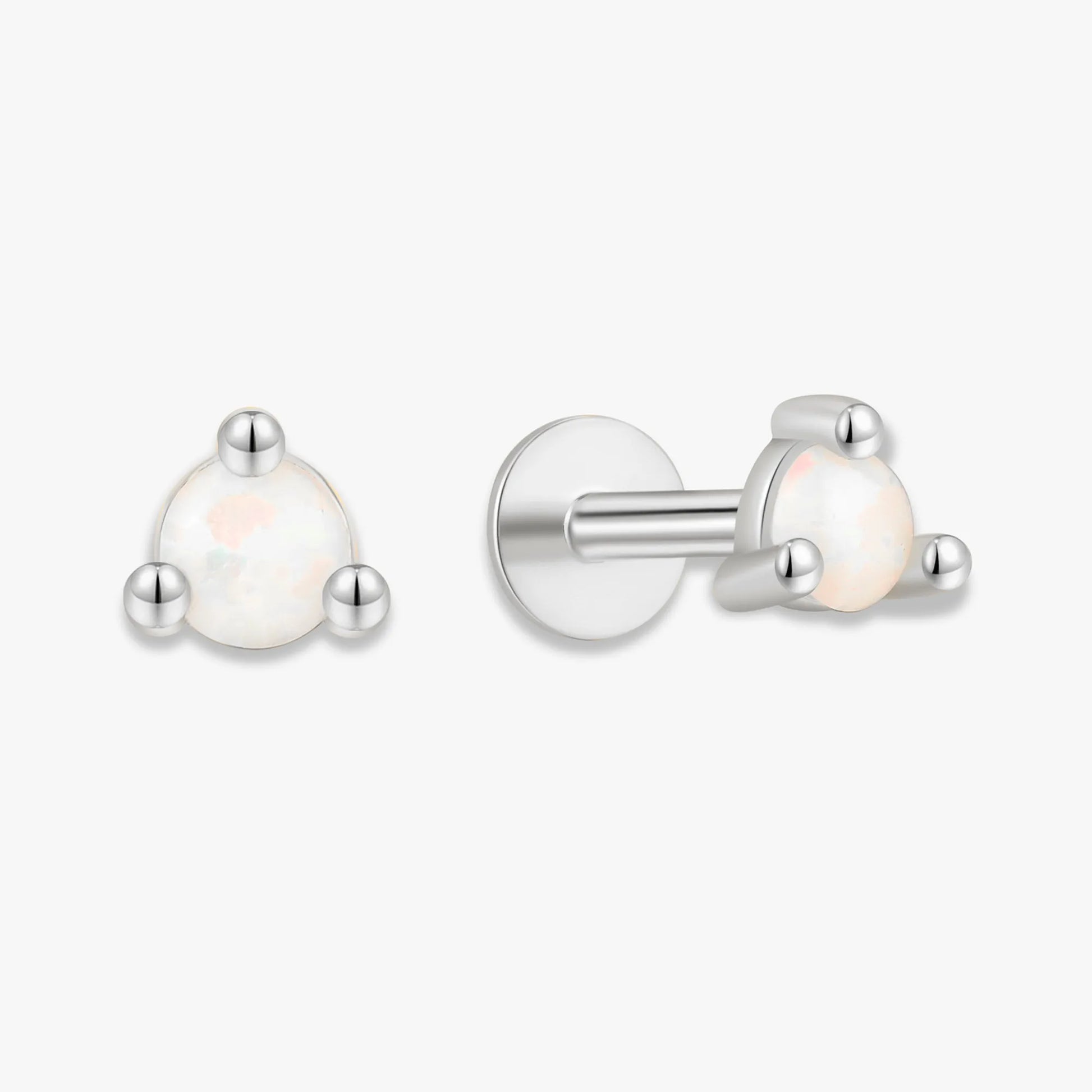 Pair of silver earrings with white gemstones on a white background