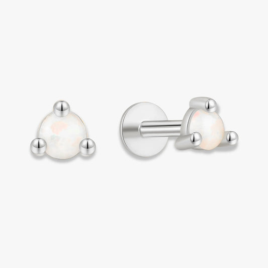 Pair of silver earrings with white gemstones on a white background