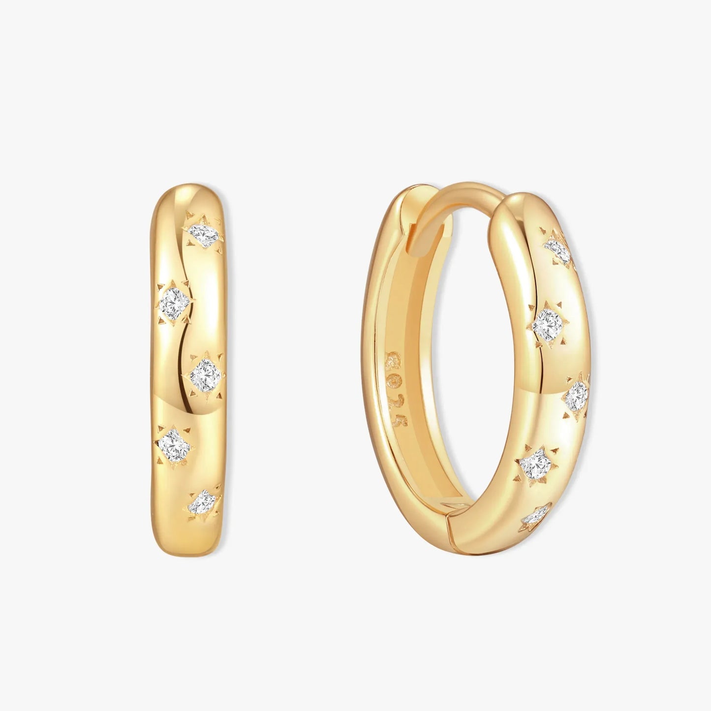 Gold hoop earrings with diamond accents on a white background
