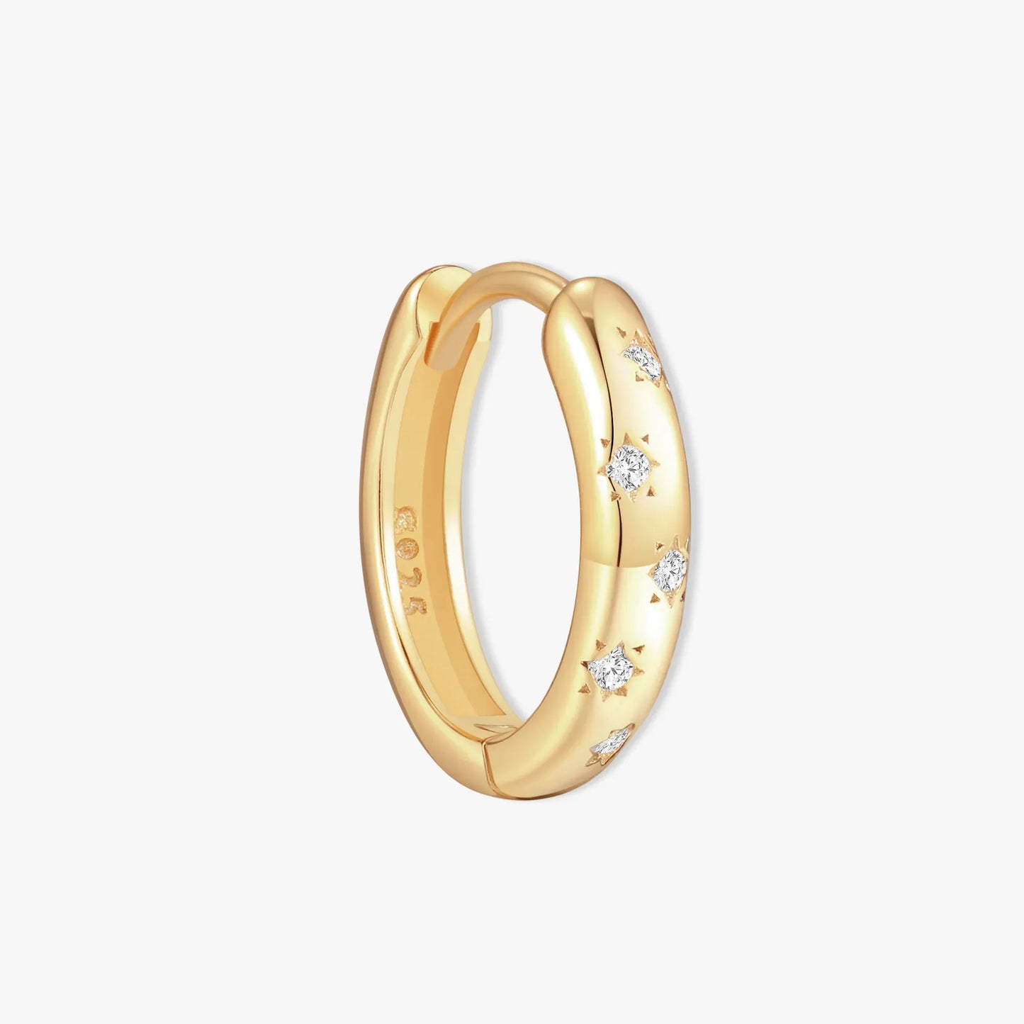 Gold hoop earring with embedded diamonds on a light gray background