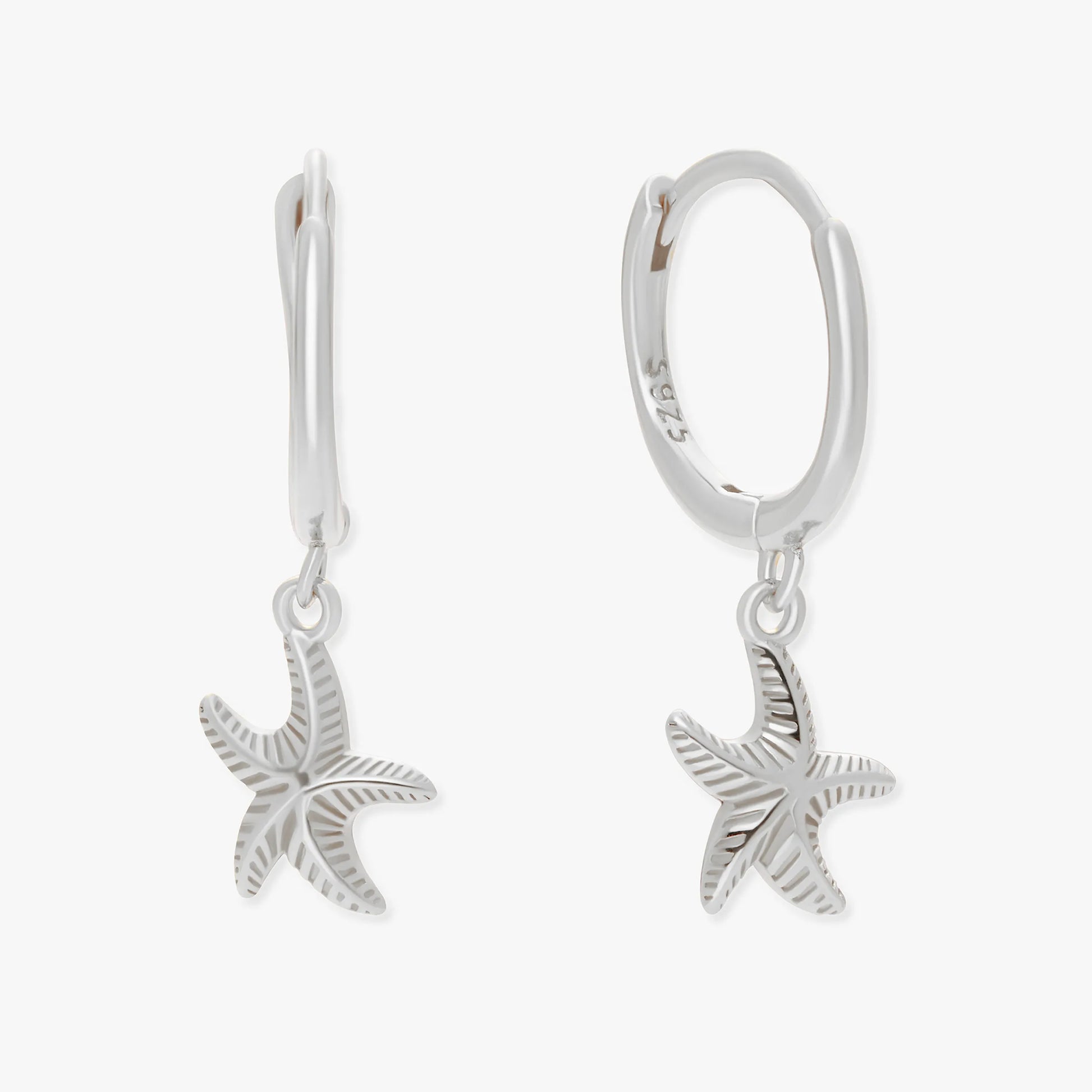 Silver starfish earrings on a white background