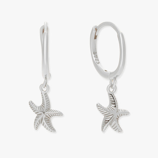 Silver starfish earrings on a white background