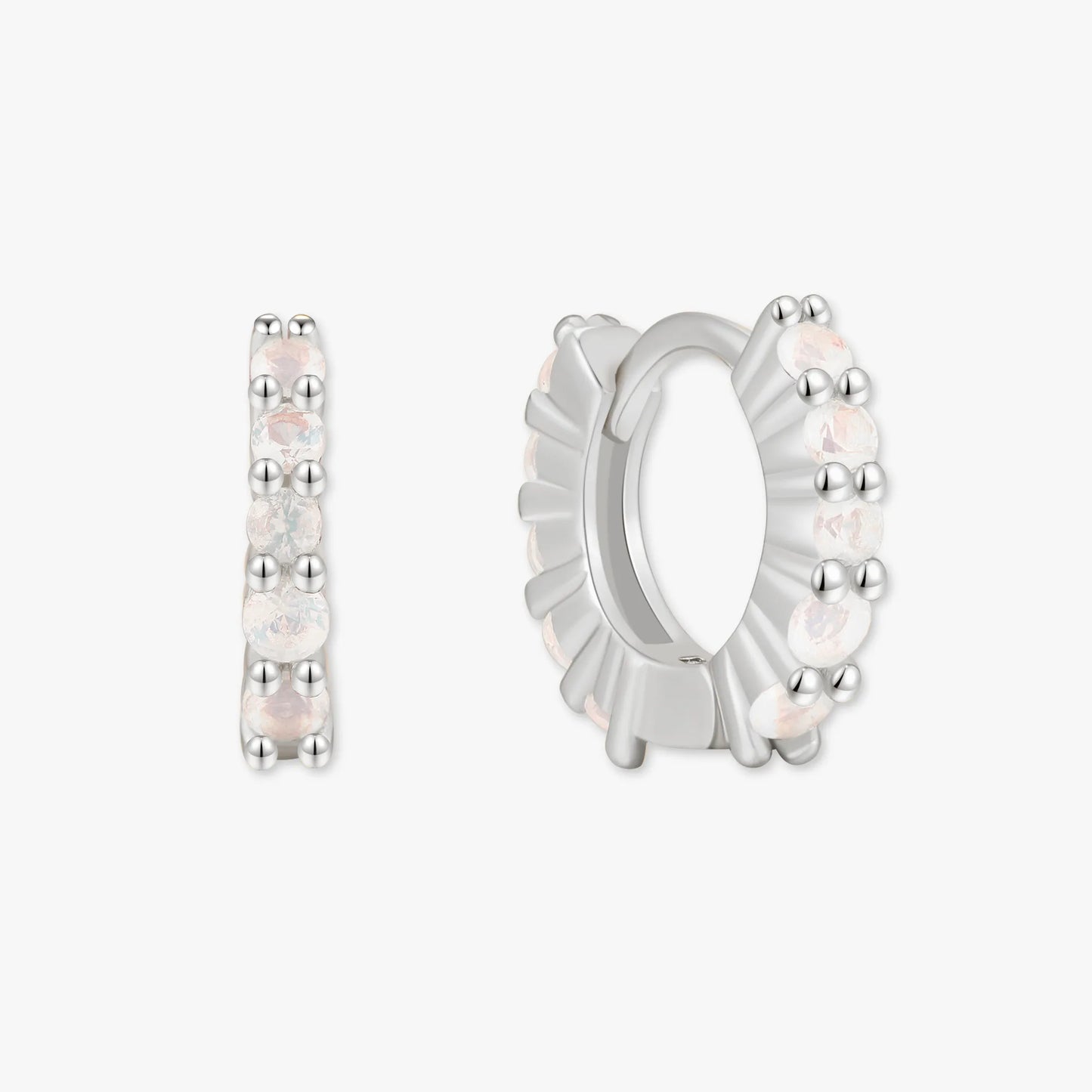 Silver hoop earrings with small stones on a white background