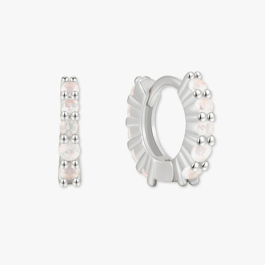 Silver hoop earrings with small stones on a white background